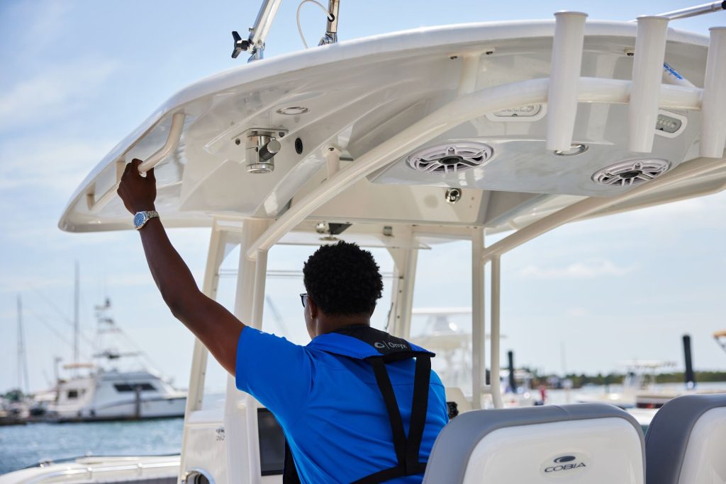 A man driving a boat, how to register a boat in Maryland concept.