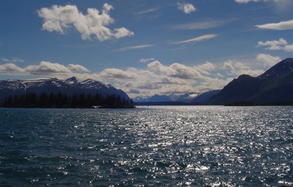 View of a lake with mountains in the background, boating in BC concept.