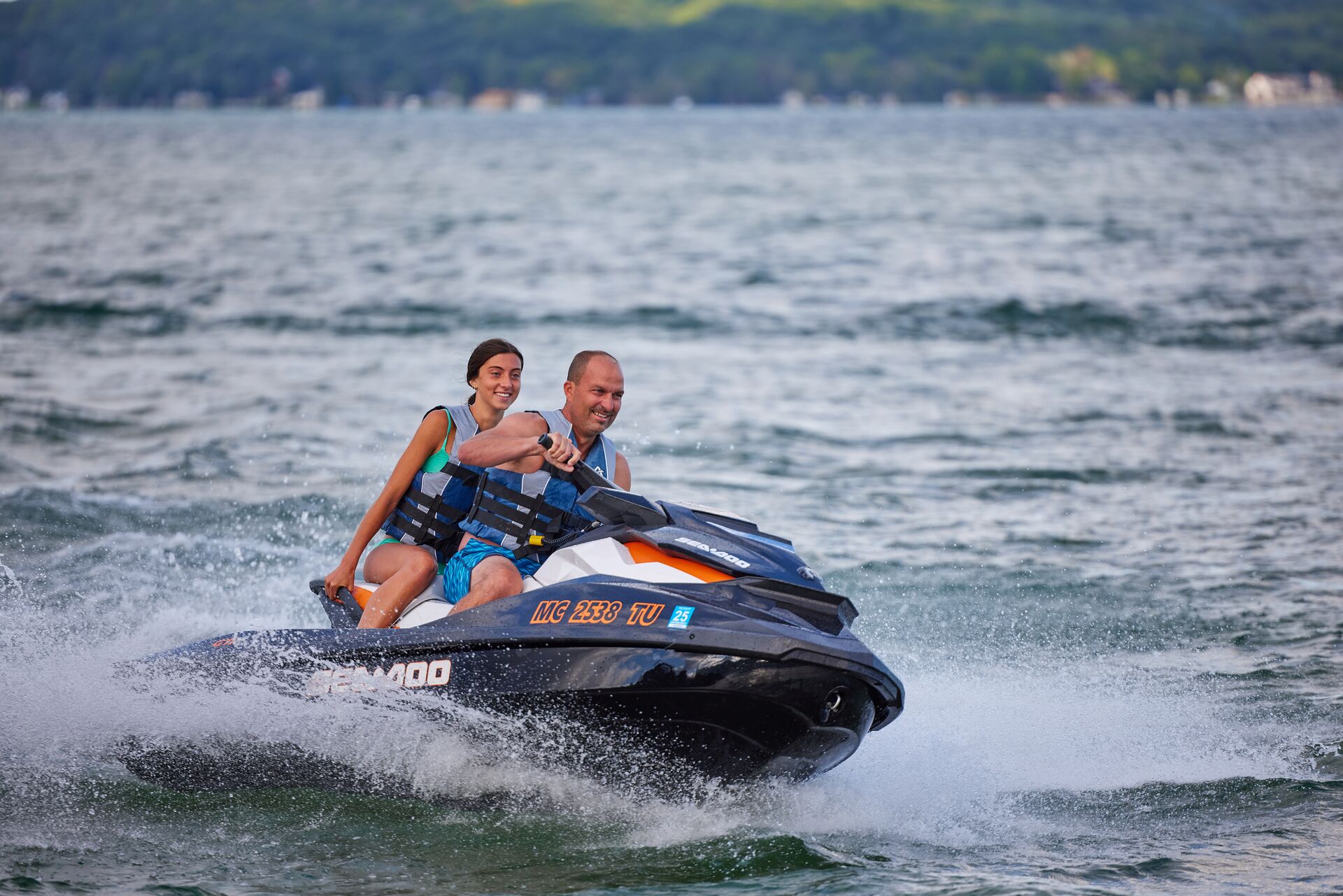 A man and girl riding a PWC, boating in Georgia concept.