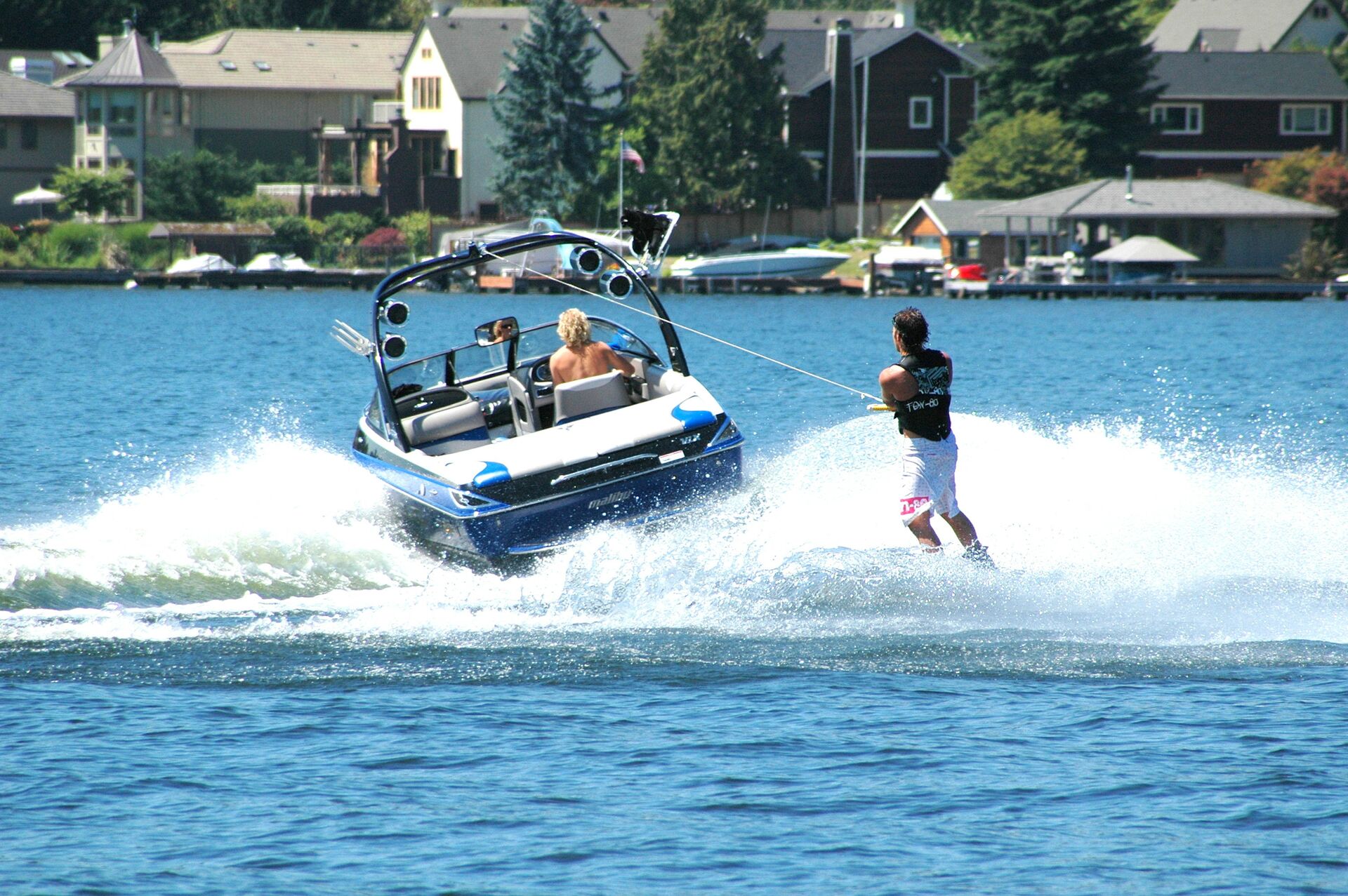 A boat pulls a guy on water skis, boating in Oklahoma concept.
