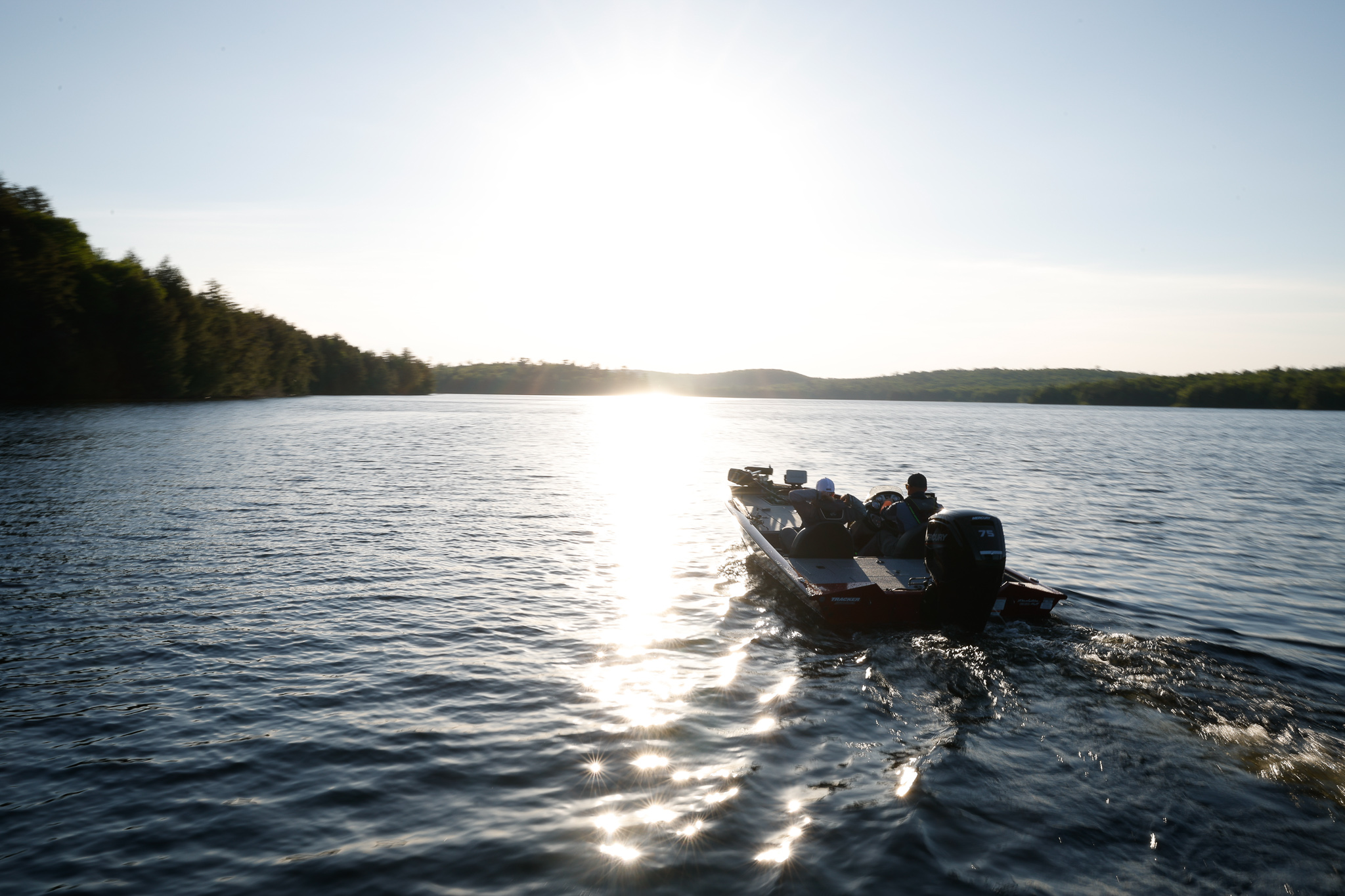 A boat moves on the water of a lake.