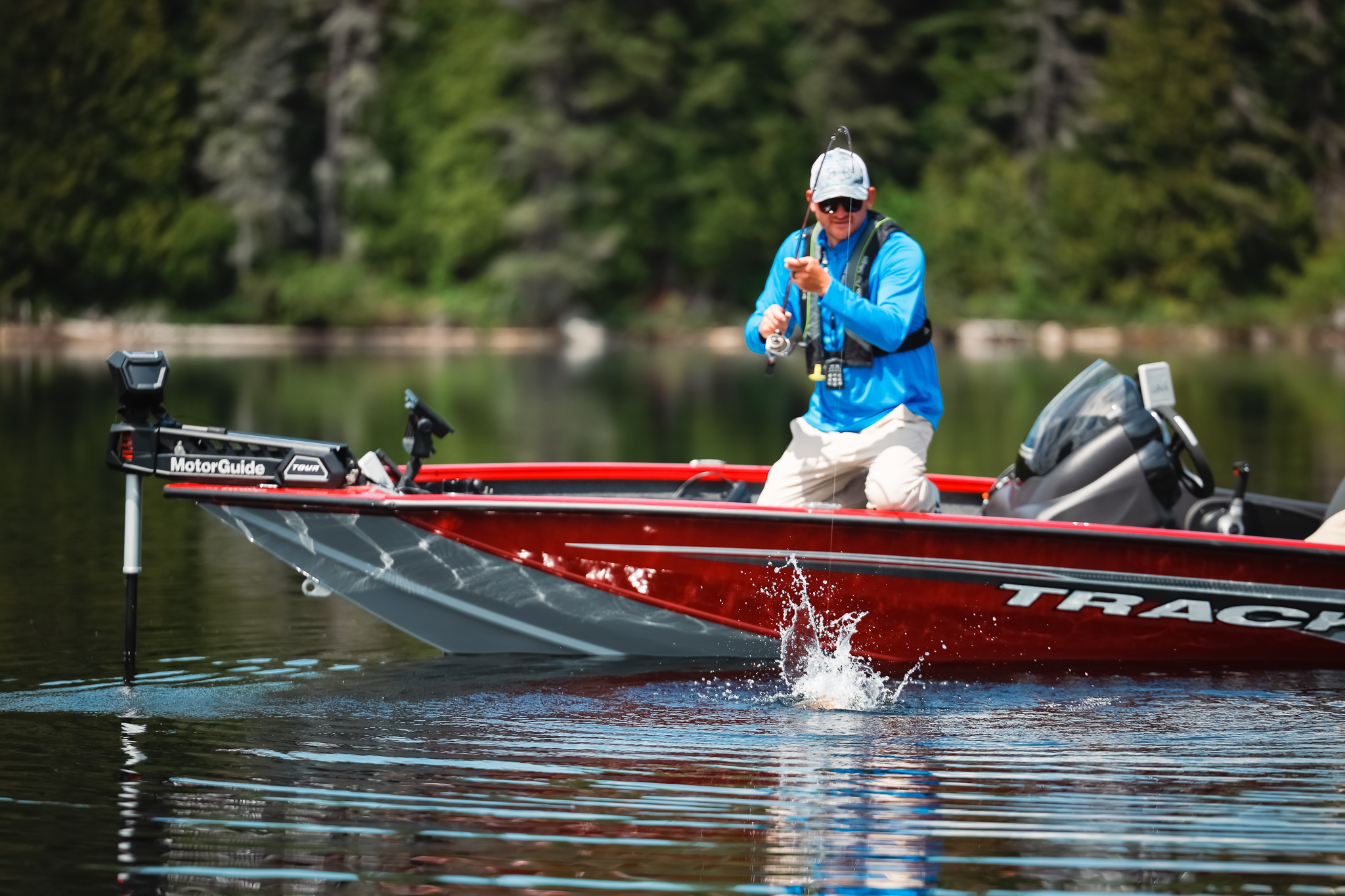 A man reeling in a fish while on a boat, boating in the Yukon concept.