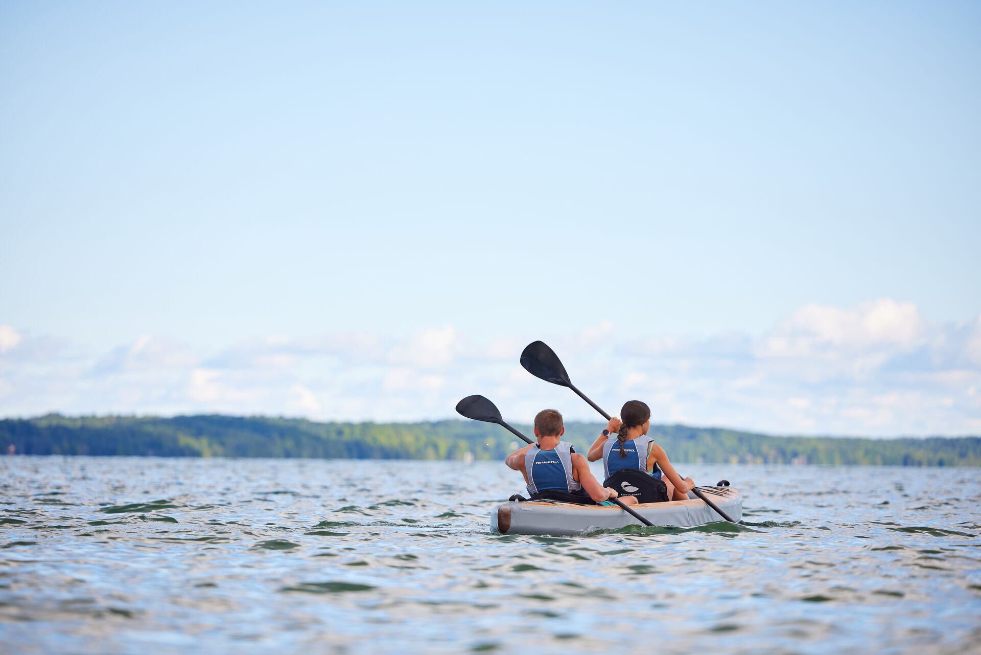 Two people paddling a kayak, understanding Hawaii boating laws and regulations concept. 