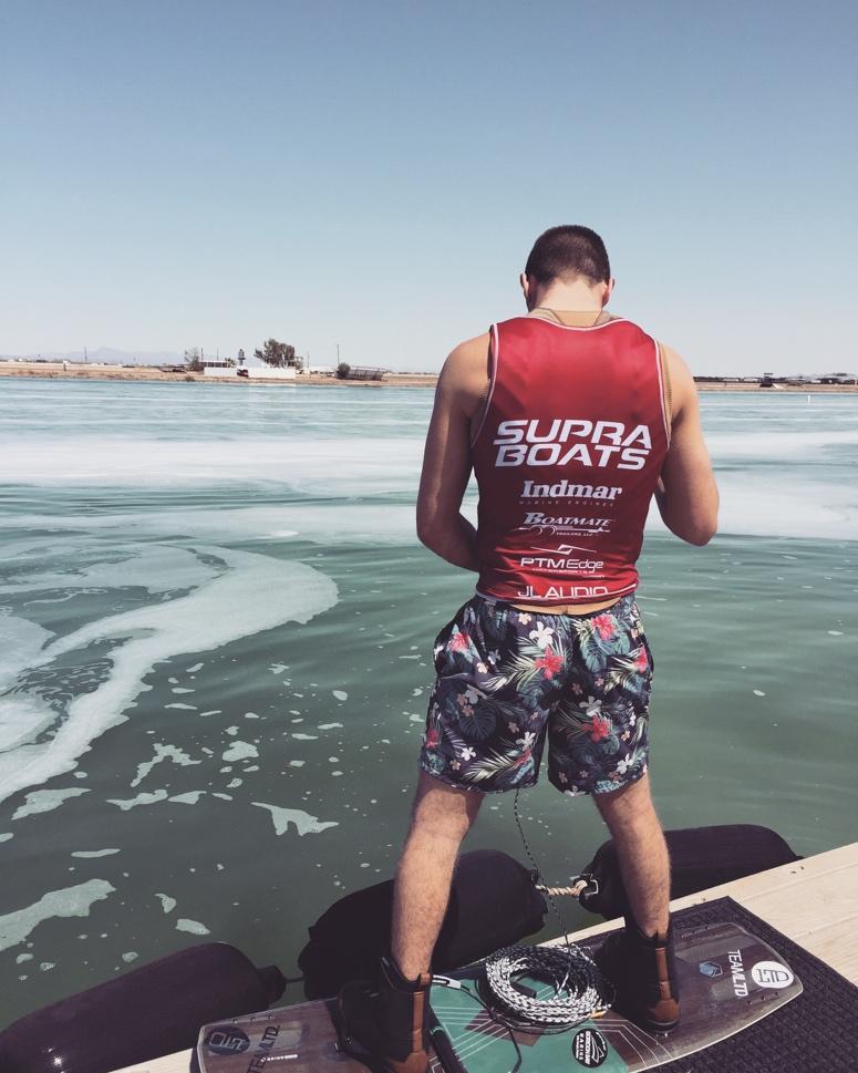A man on a wakeboard on the dock