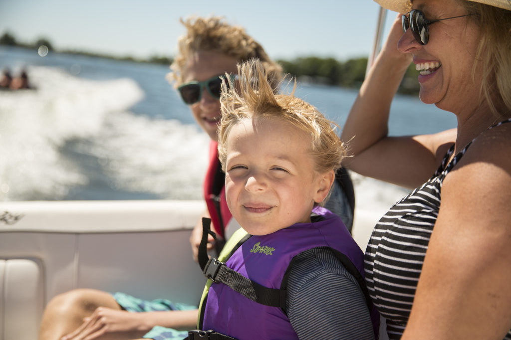 A child and women on a boat, check boat access during a pandemic concept. 