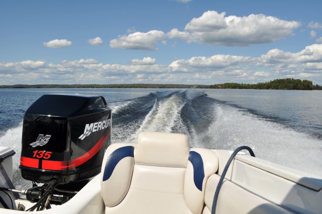 Looking out of the back of a boat in motion on the water, boating in California concept.
