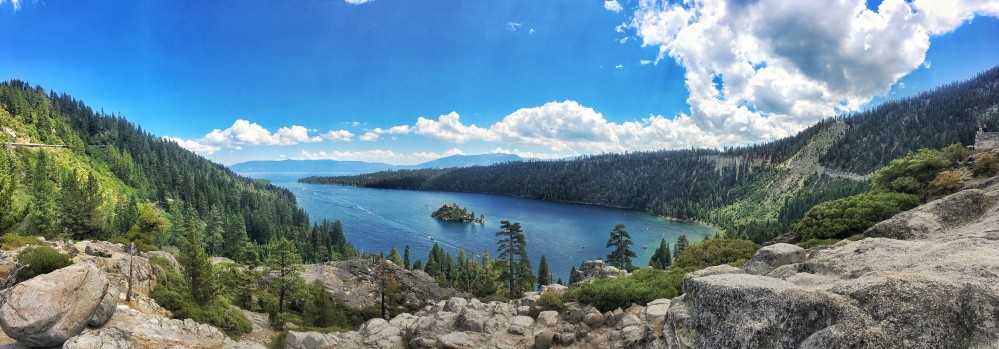Panoramic view of a lake surrounded by hills, boating in California concept.