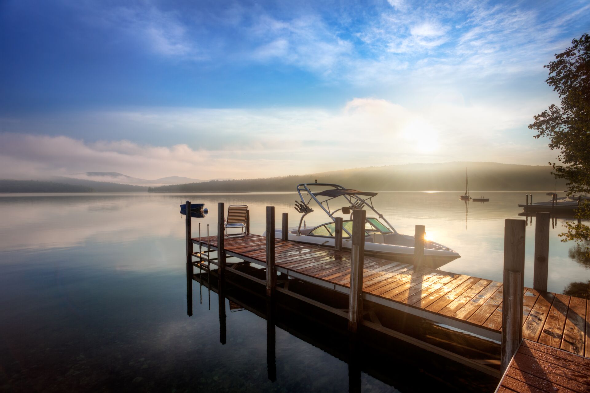 A boat at the dock at sunset. 
