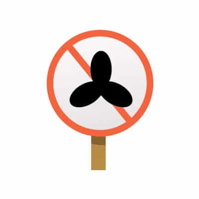 Round sign with an orange circle and diagonal slash over a black propeller