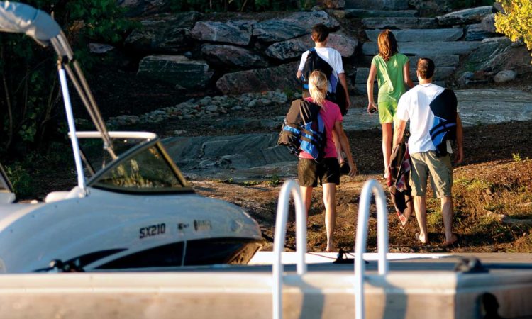 family arriving at cottage via boat